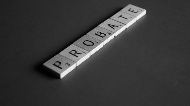 Letter tiles spelling PROBATE on a dark surface