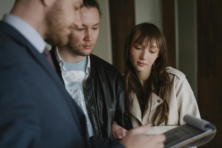 Three people looking at a tablet together indoors